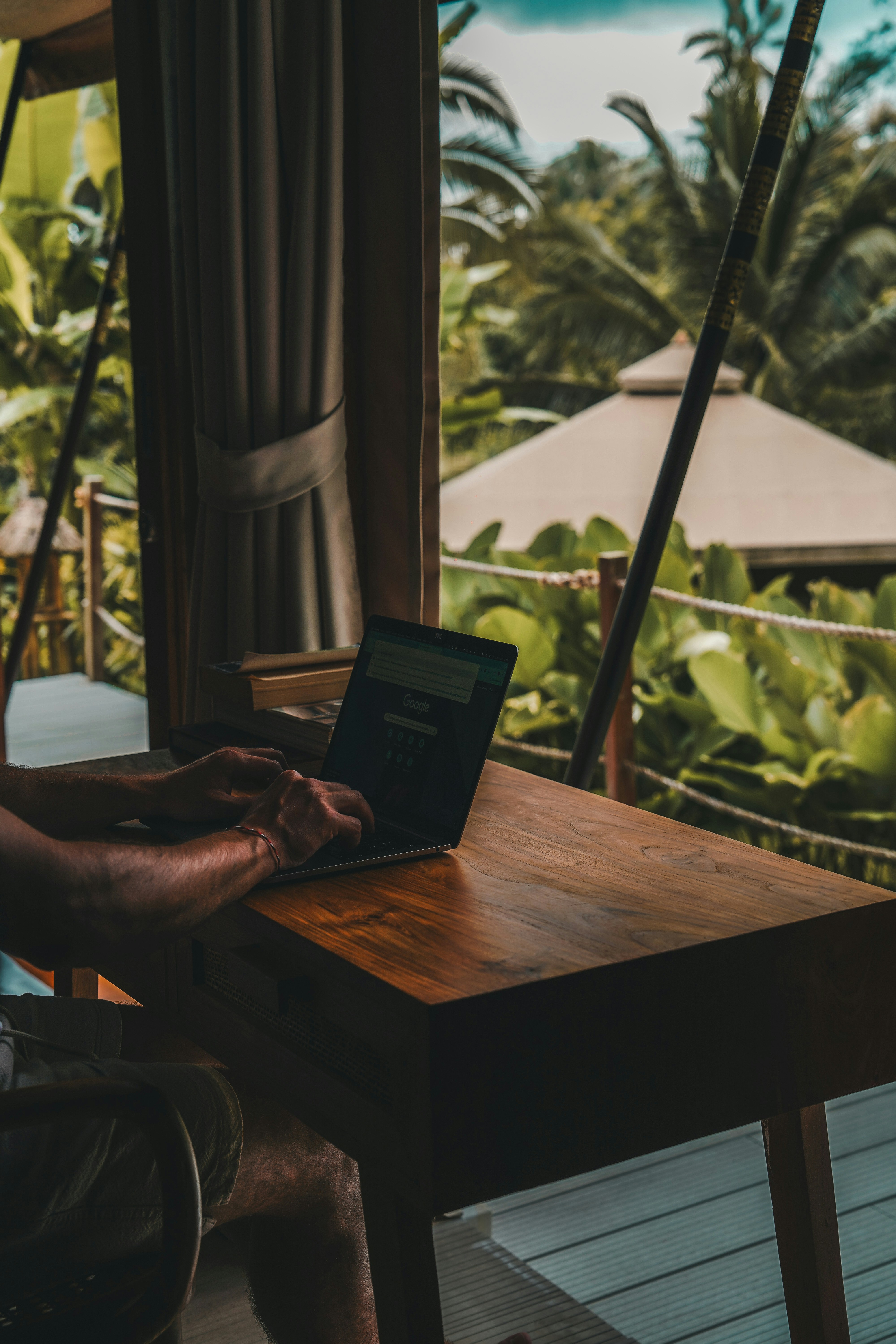 Working on a laptop from a jungle villa